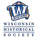 Two of the three mitchell park glass domes are lit up in blues, purples, and reds at night.